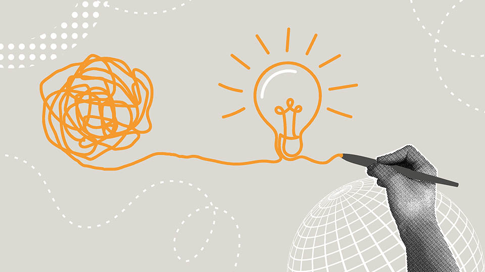 Hand drawing a light bulb from a ball of yarn
