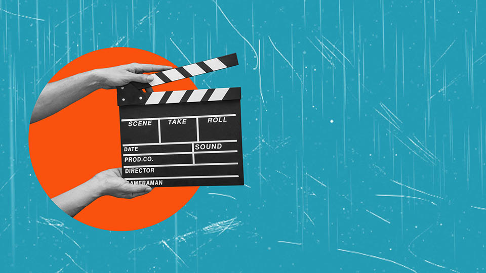 Hands holding clapper board making video cinema in studio
