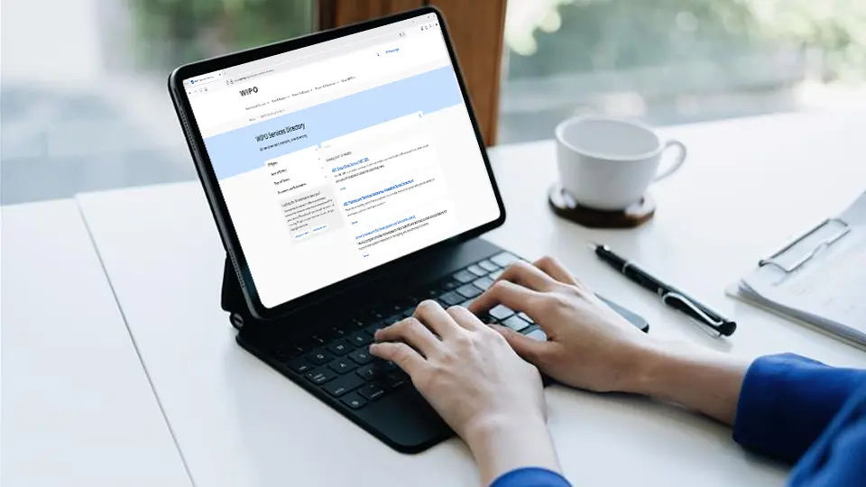 Woman consulting the WIPO Services Directory database on a tablet