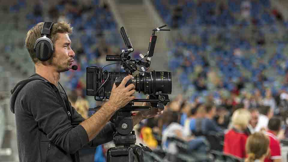 Camera man is filming to broadcast a sports tournament on television