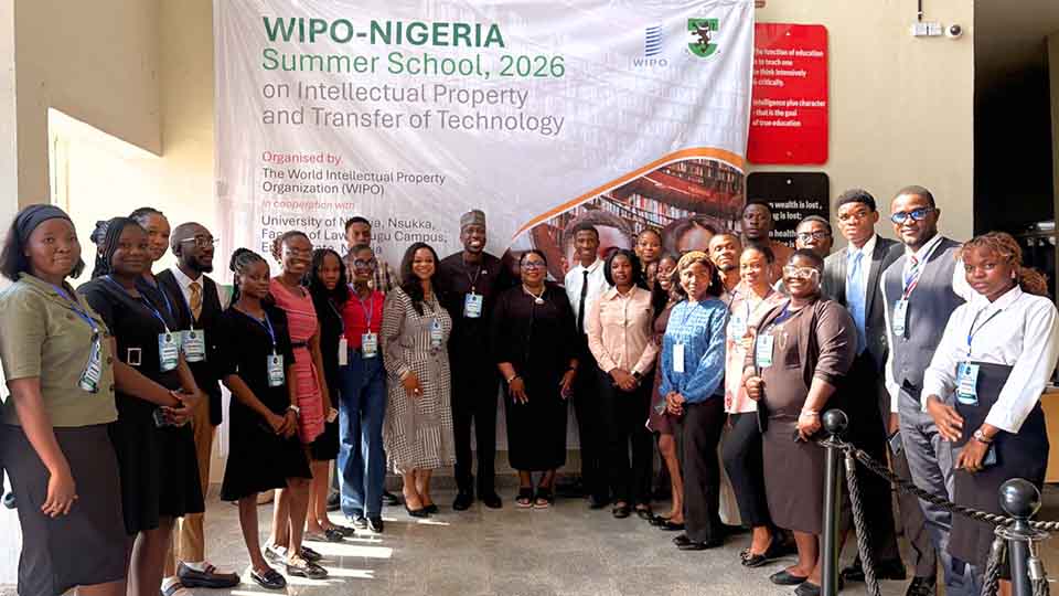 Large group of participants and officials standing together in front of the WIPO-Nigeria Summer School 2026 banner on Intellectual Property and Transfer of Technology